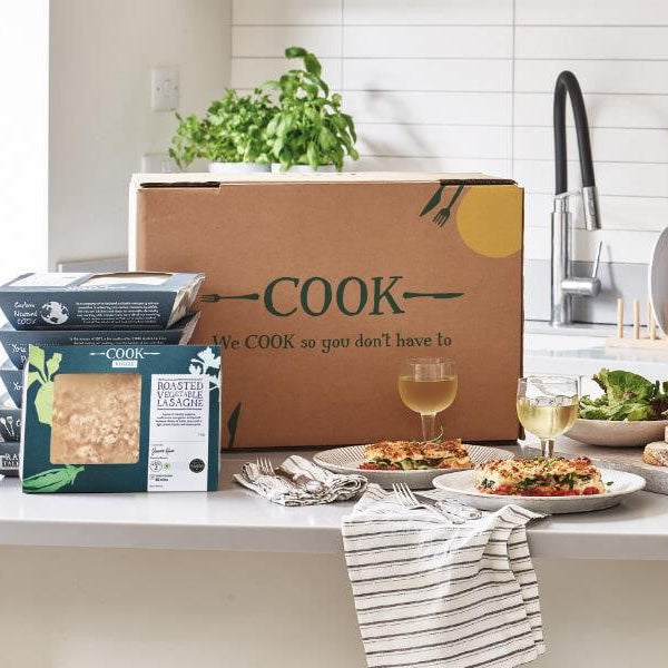 Kitchen counter with food items and a 'COOK' box, featuring a modern kitchen setting.